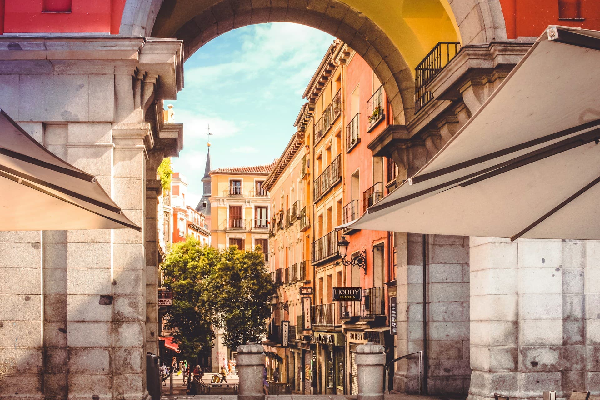 Street view exit from Plaza Mayor toward Calle de Felipe III and Calle Mayor in central Madrid.