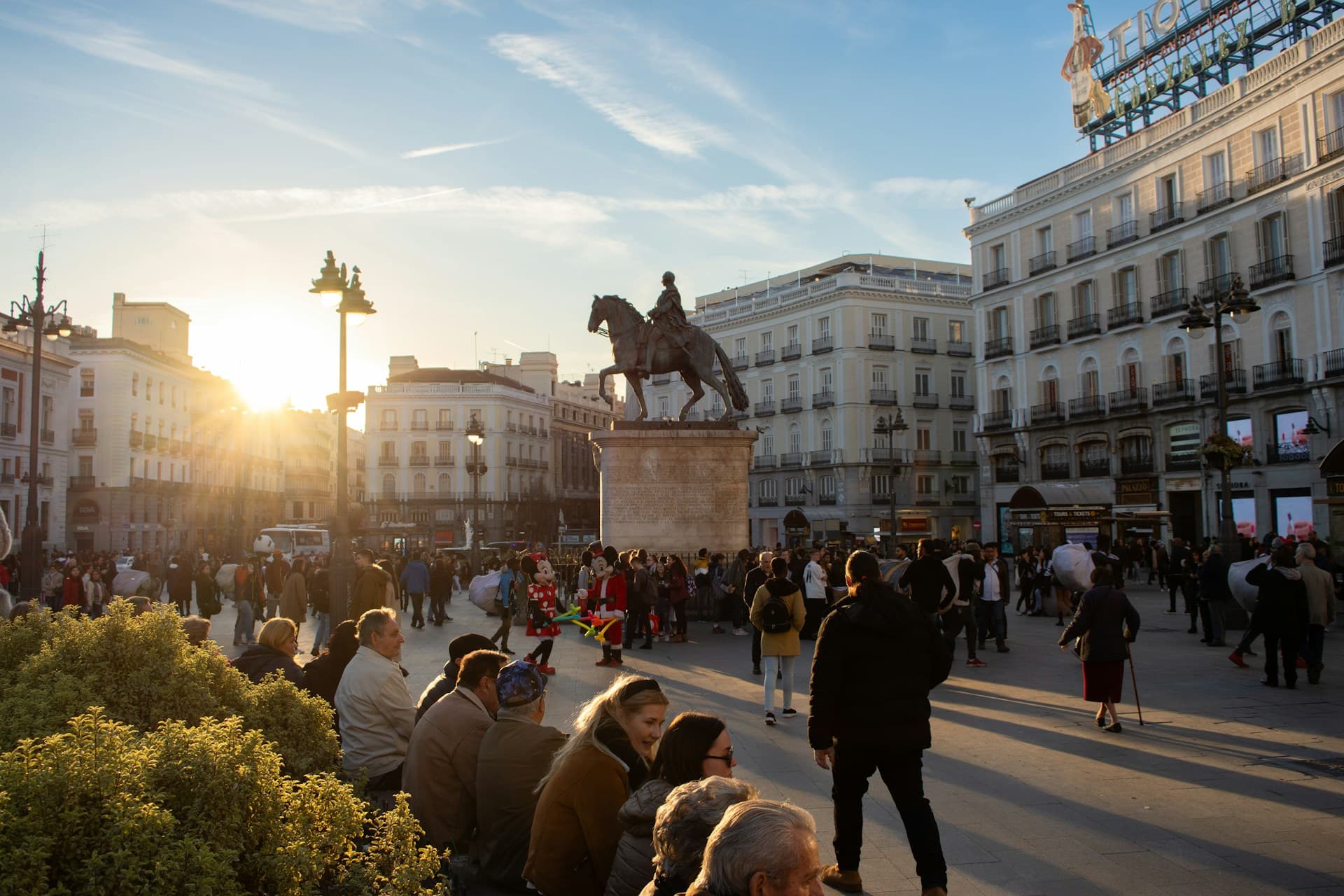 The Carlos III statue and Tio Pepe iconic advert in Puerta del Sol in central Madrid, the hyper-center of the city known for its historic buildings and constant energy.